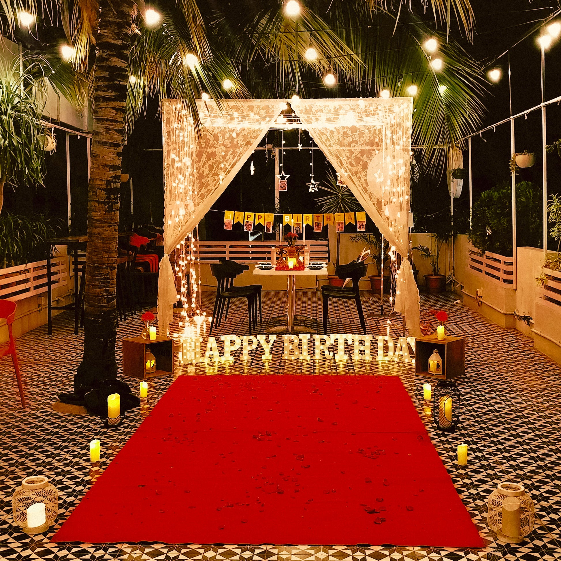 Romantic cabana setup with candles and lights for a birthday celebration in Hyderabad at Bel Posto Cafe.