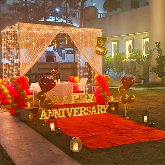 Beautifully arranged private cabana for anniversary celebrations in Hyderabad with cold firecrackers and rose petals.